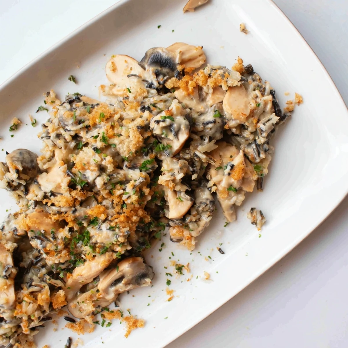 This photo features a warm, creamy Creamy Mushroom and Wild Rice Casserole, perfect for a dinner party.