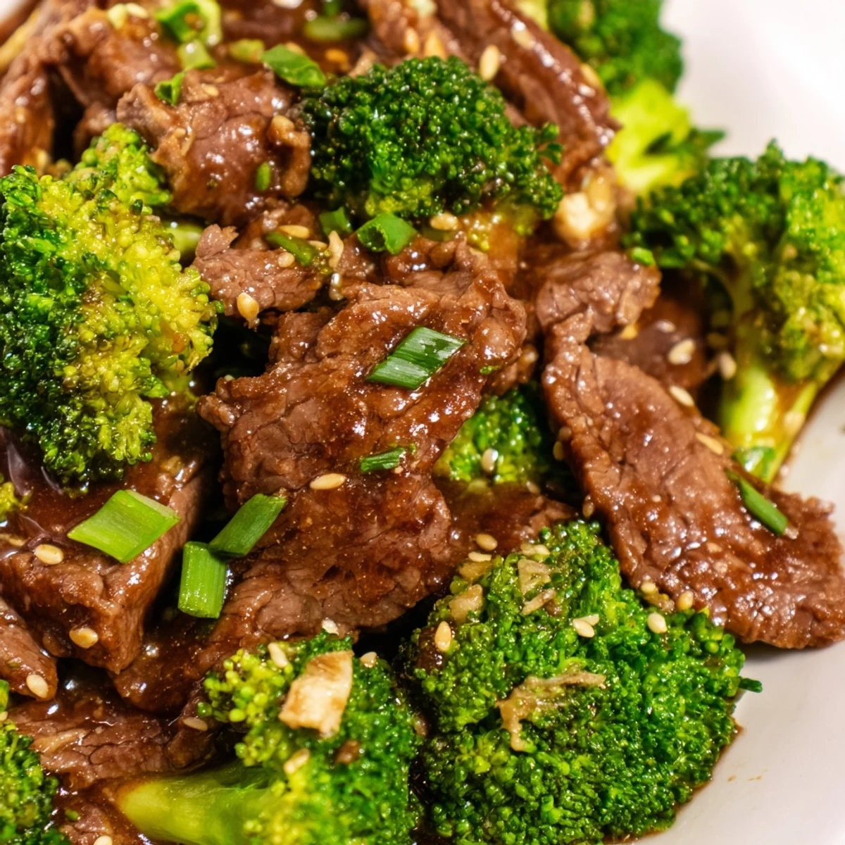 Overhead view of Keto Friendly Beef and Broccoli Stir Fry beside cauliflower rice and sesame garnish, perfect for weeknight family dinners.