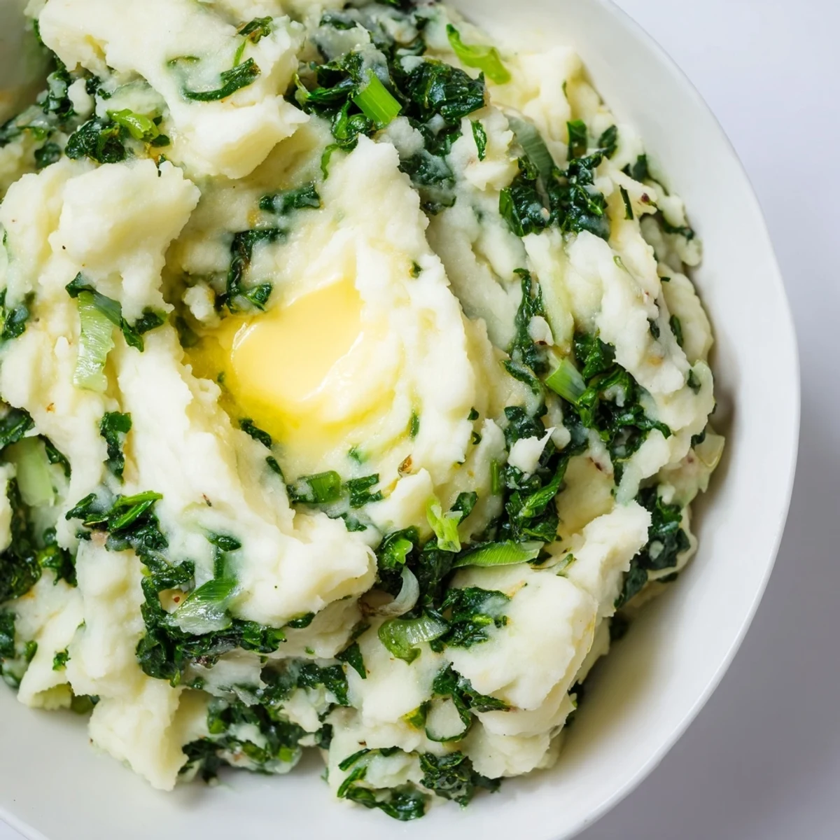 Vibrant Irish Colcannon mashed potatoes feature kale and scallions mixed into fluffy, buttery mash.