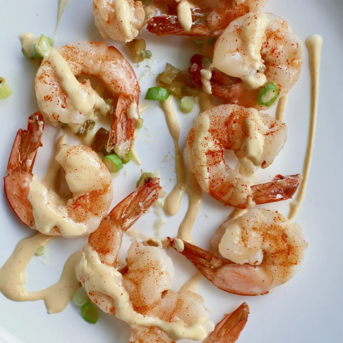 Golden-brown sautéed shrimp piled high, drizzled with creamy, spicy Cajun Remoulade Sauce and fresh lemon wedges.