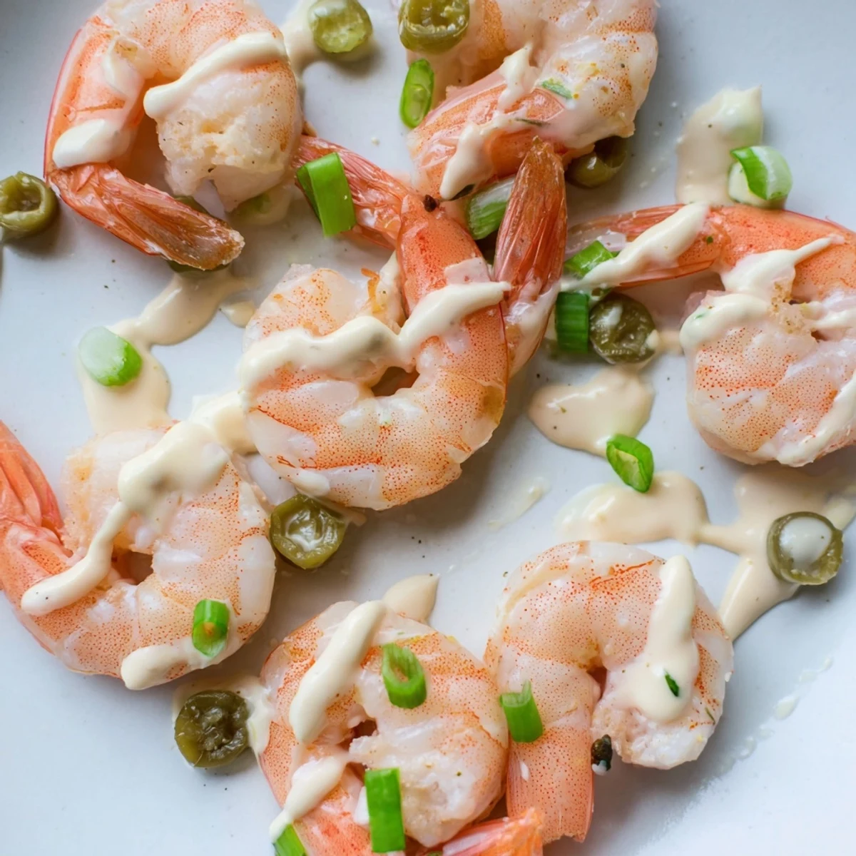 Serve this Cajun Remoulade Sauce with Shrimp as a vibrant appetizer on a platter with extra sauce for dipping.