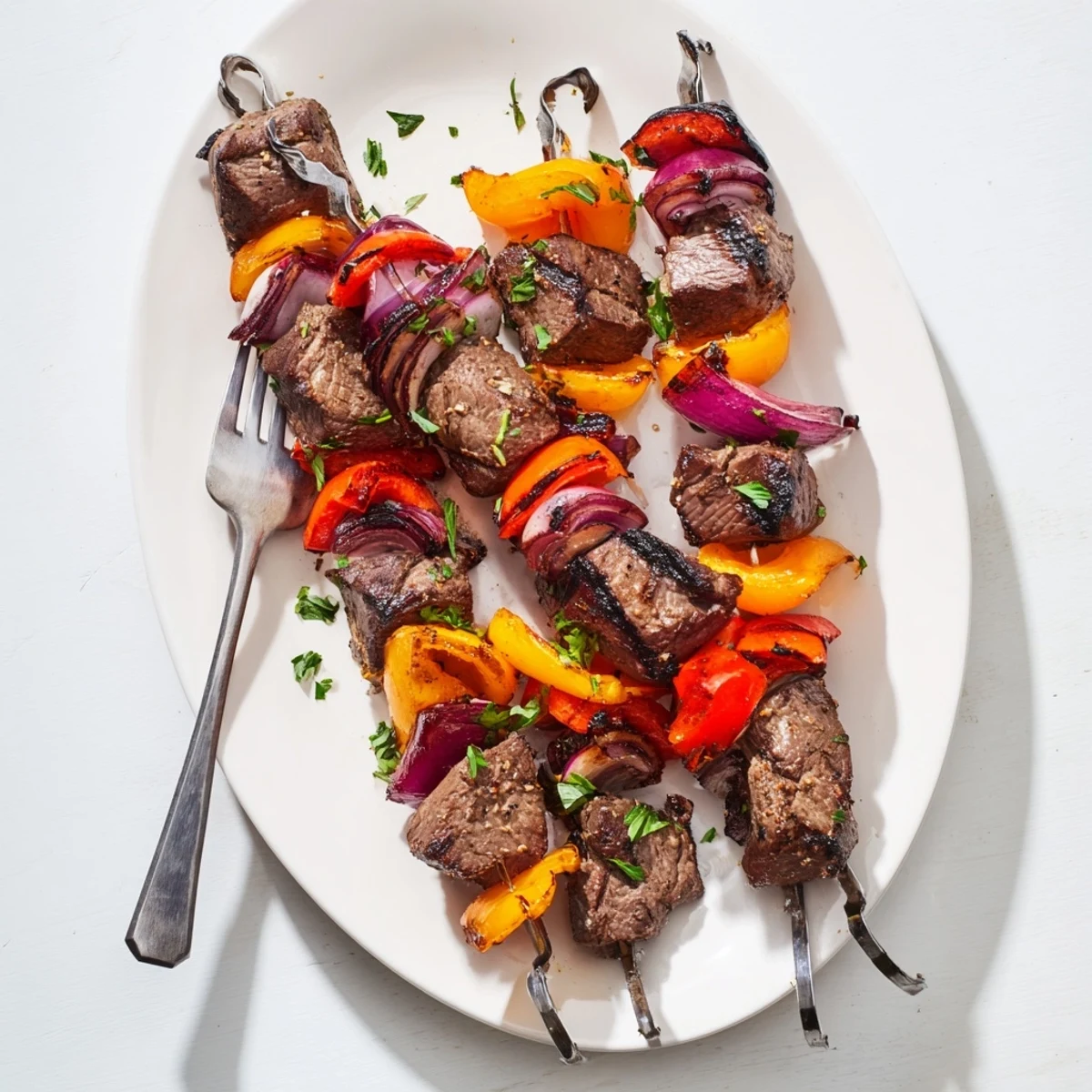 Tender marinated beef cubes and vibrant peppers on a grill, creating a classic barbecue aroma.