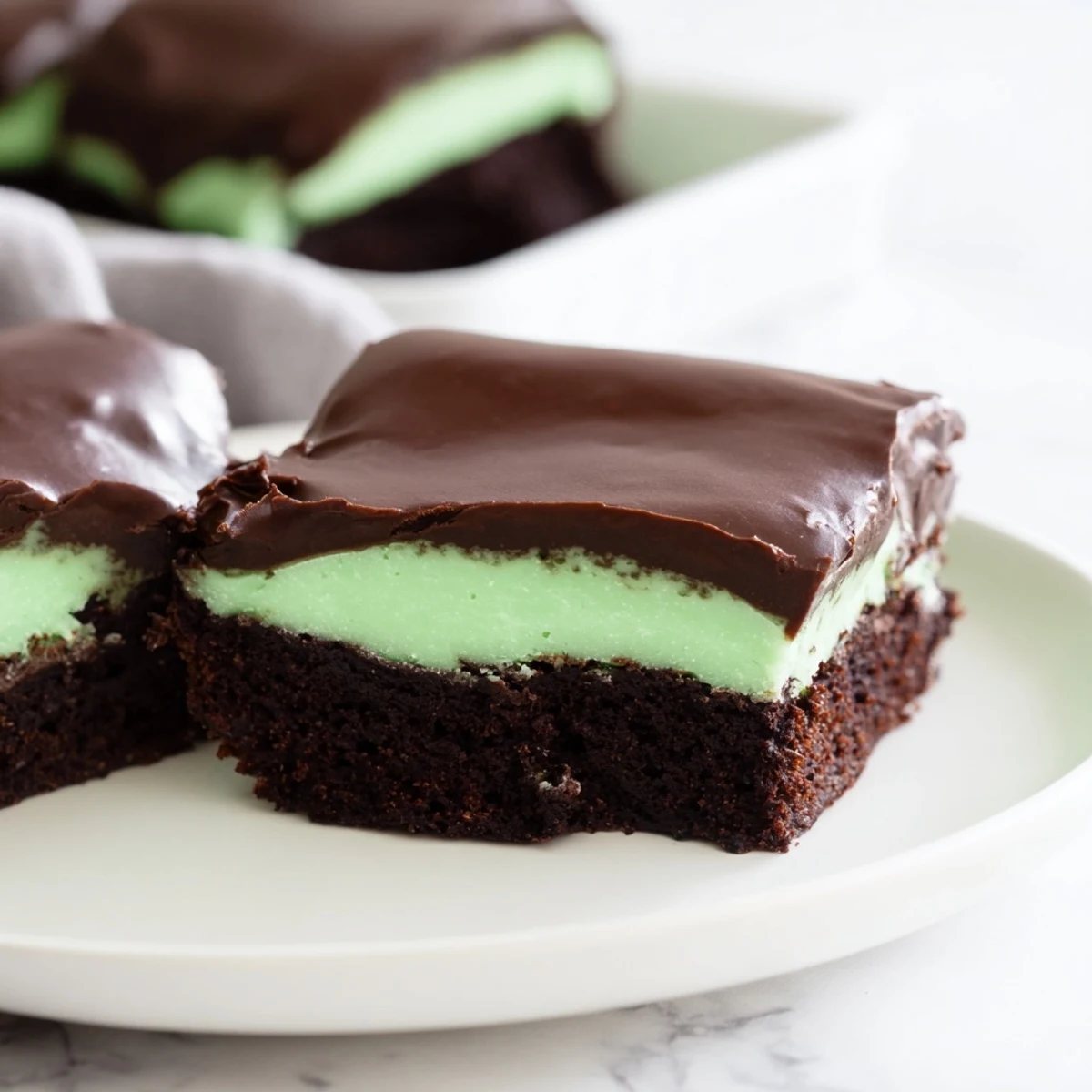 Freshly baked Shamrock Mint Brownies with a rich fudgy chocolate base and a vibrant green mint cream layer.  