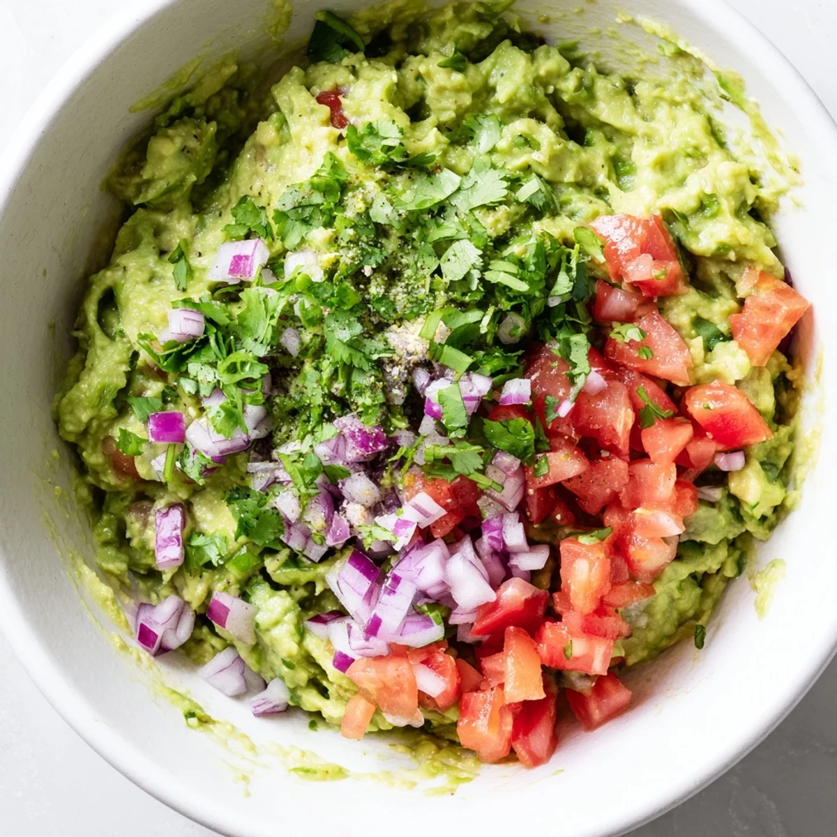 Freshly mashed guacamole with lime and cilantro, layered with a vibrant pico de gallo for a cool, spicy dip.