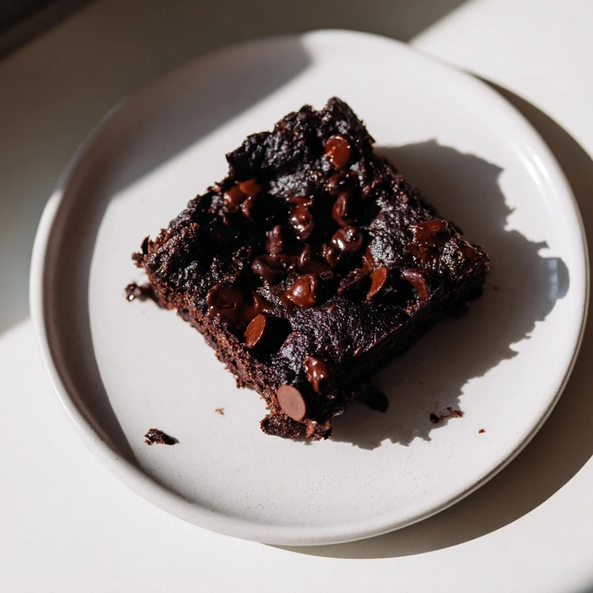 A close-up of Gluten-Free Almond Flour Brownies with a rich, fudgy texture and glossy melted chocolate chips on top.
