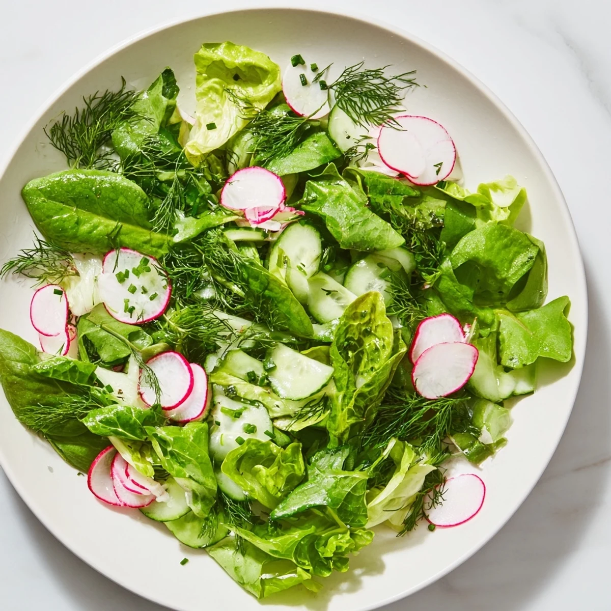 A light Spring Garden Salad tossed with lemony dressing, perfect as a refreshing side dish.