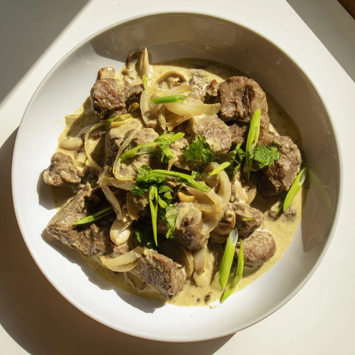 A close-up view of Lemongrass Coconut Braised Beef with Mushrooms in a rustic Dutch oven.