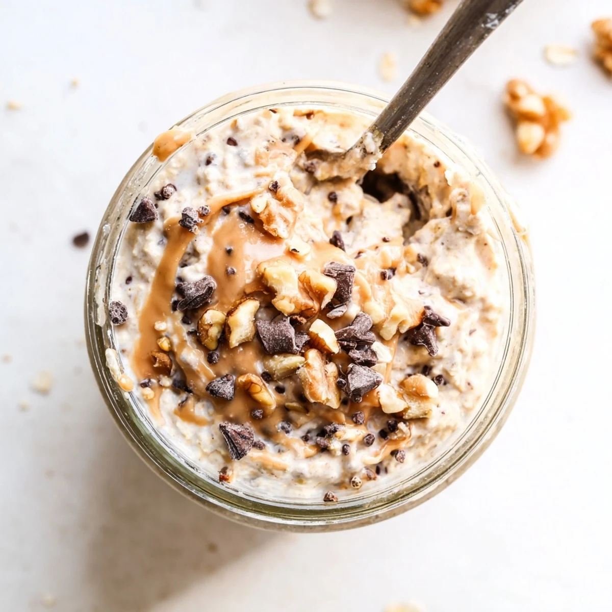 Healthy Cookie Dough Overnight Oats in a jar, layered with chia seeds and mini chocolate chips.