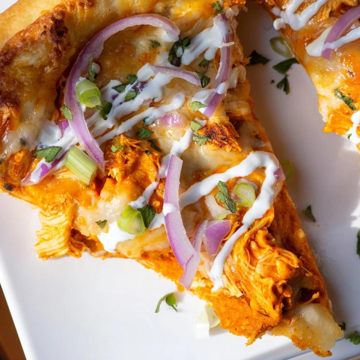 Golden Bold Buffalo Chicken Pizza topped with melted mozzarella, cheddar, spicy shredded chicken, and fresh scallions on a wooden cutting board.