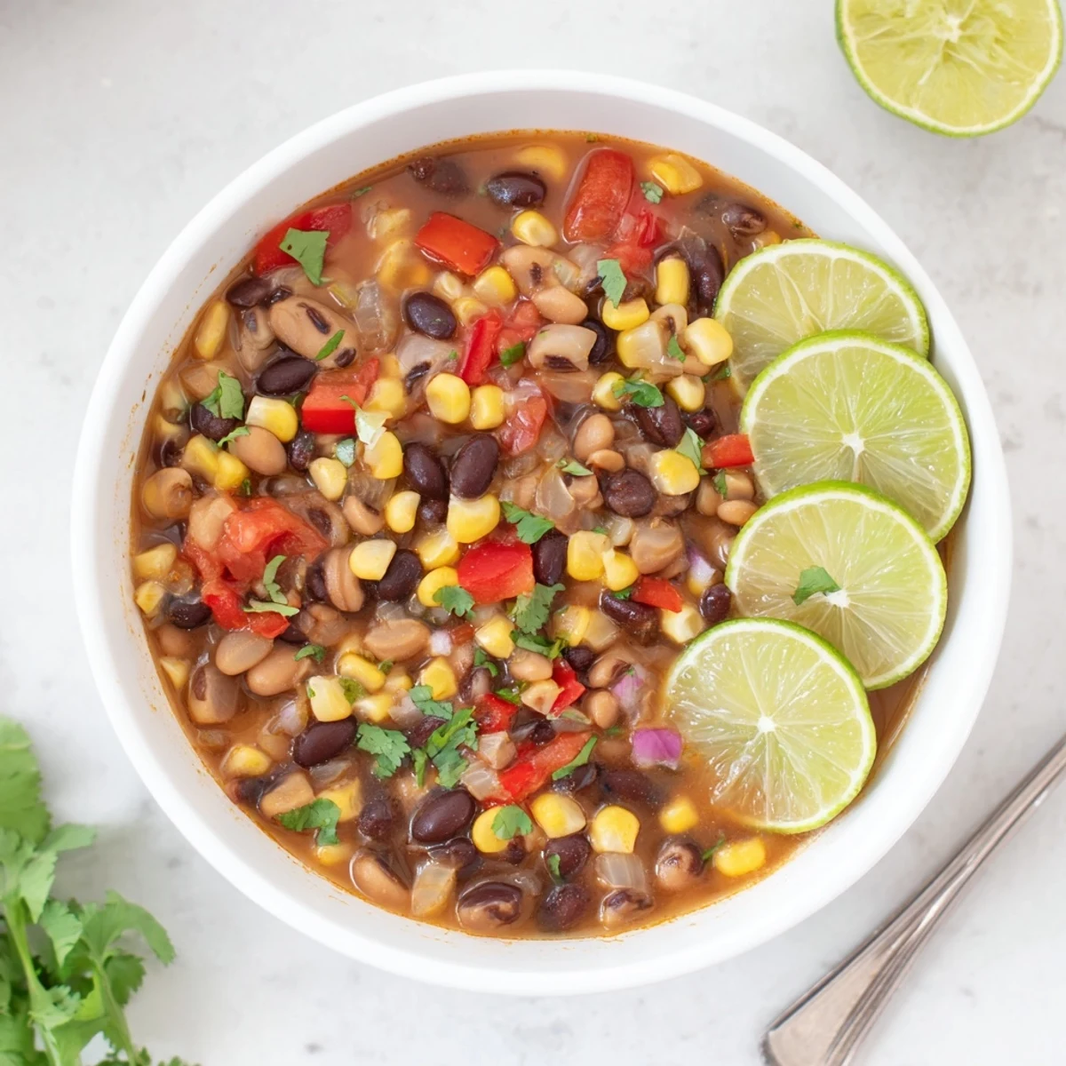 Hearty vegan Black Bean Corn Chili Lime Delight in a rustic bowl with visible corn and beans.
