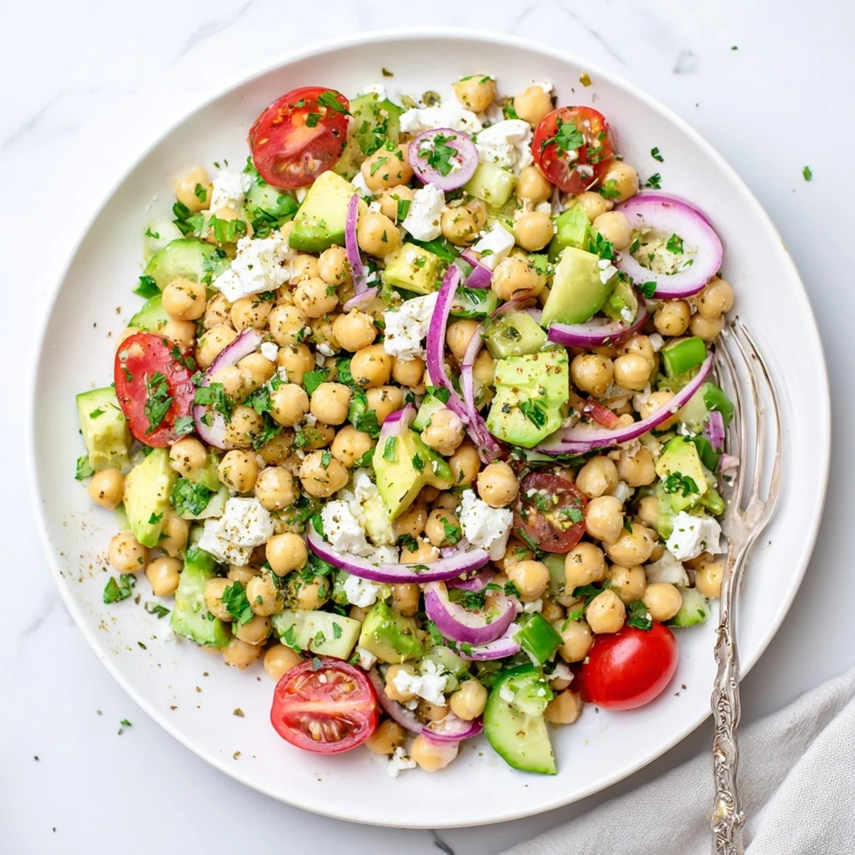 This vibrant Chickpea Feta Avocado Salad is tossed with a zesty lemon dressing and ready for a healthy lunch.