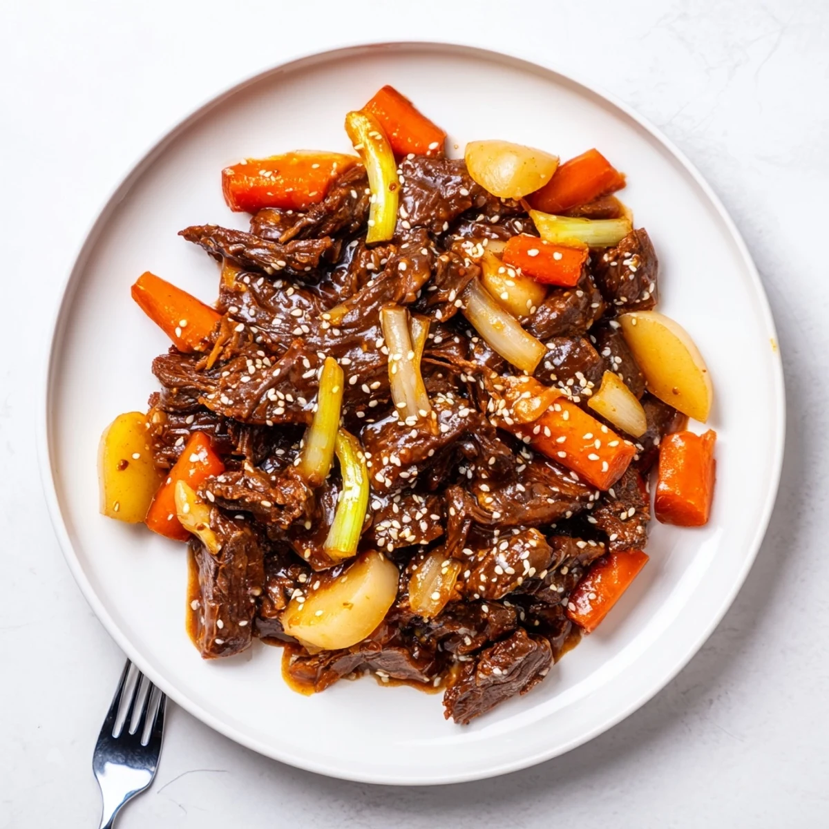 Juicy Korean Style Pot Roast garnished with sesame seeds, ready to serve alongside steamed rice and kimchi.