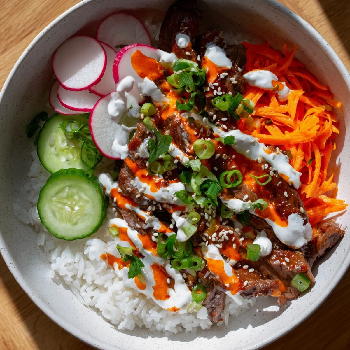 A vibrant bowl featuring tender beef, crisp vegetables, and spicy sauce next to chopsticks in Korean BBQ Steak Rice Bowls.