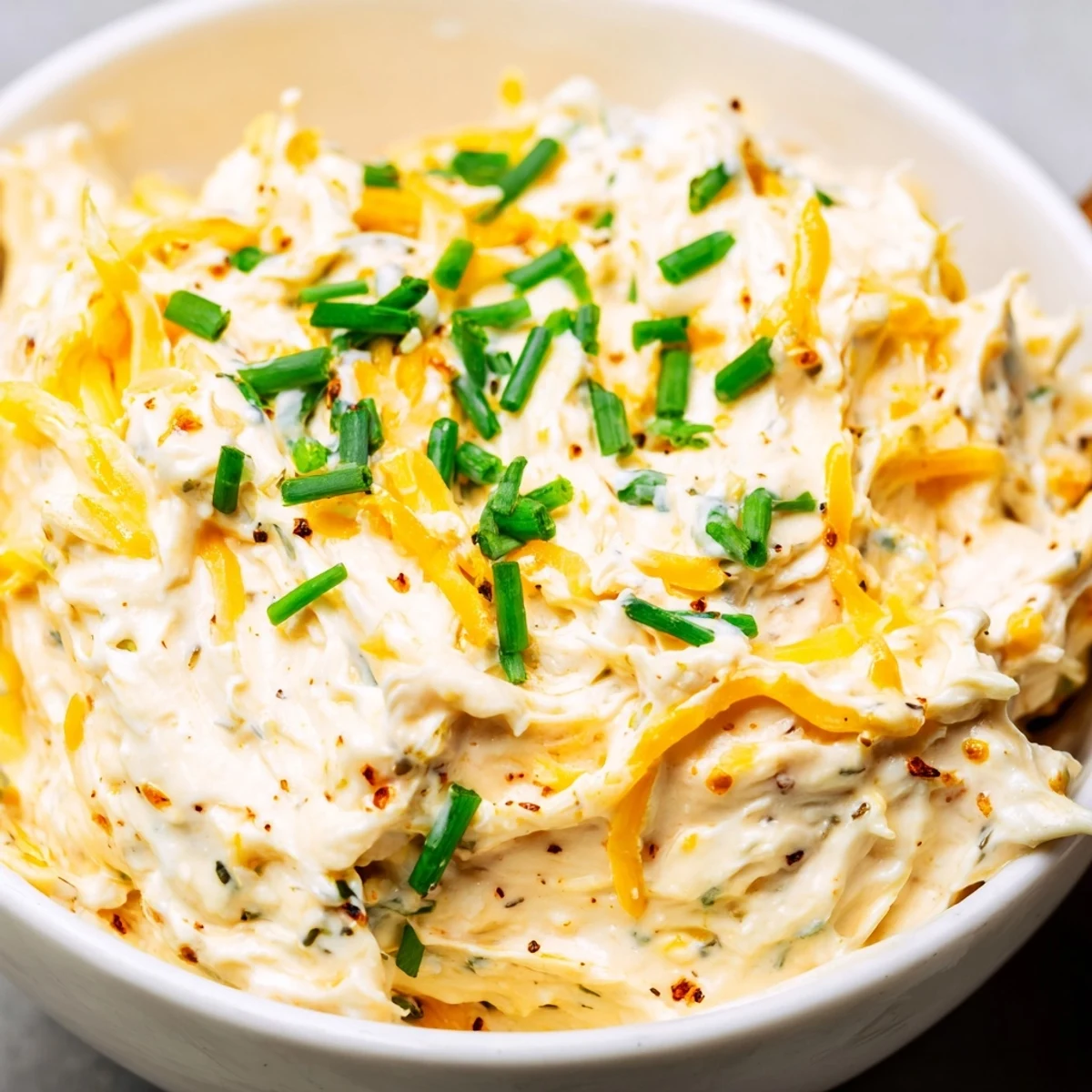 Thick and tangy savory pretzel dip sprinkled with green onions, perfect for party appetizers