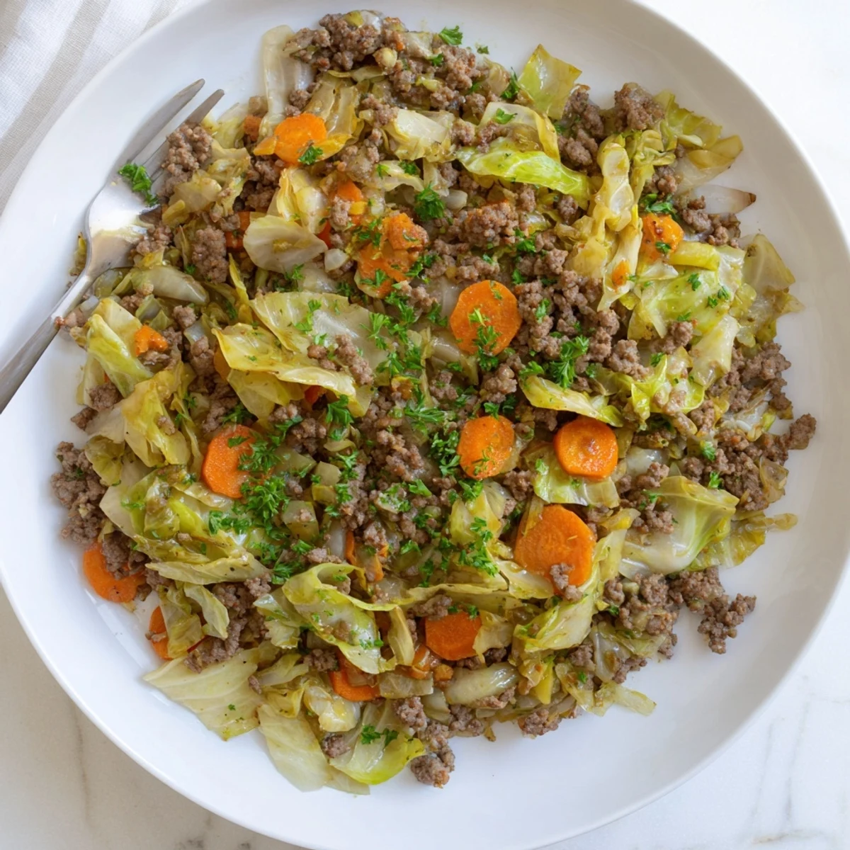 Hearty Irish ground beef and cabbage skillet featuring caramelized onions and wilted green cabbage