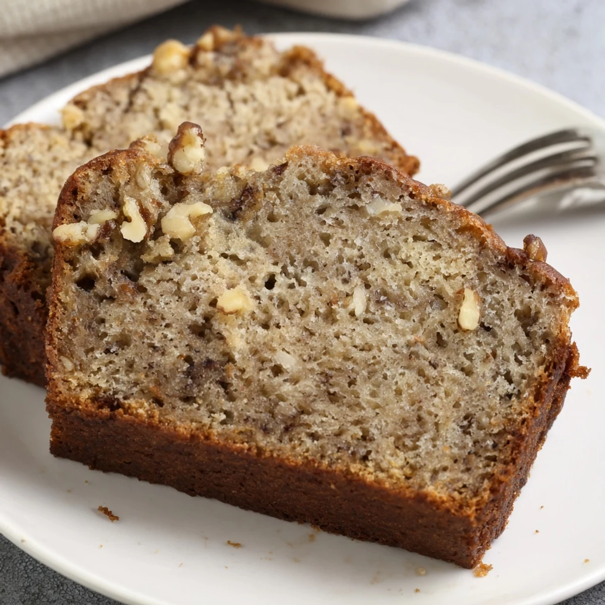 Warm ultimate banana nut bread fresh from the oven with a perfectly domed top and crunchy walnut topping