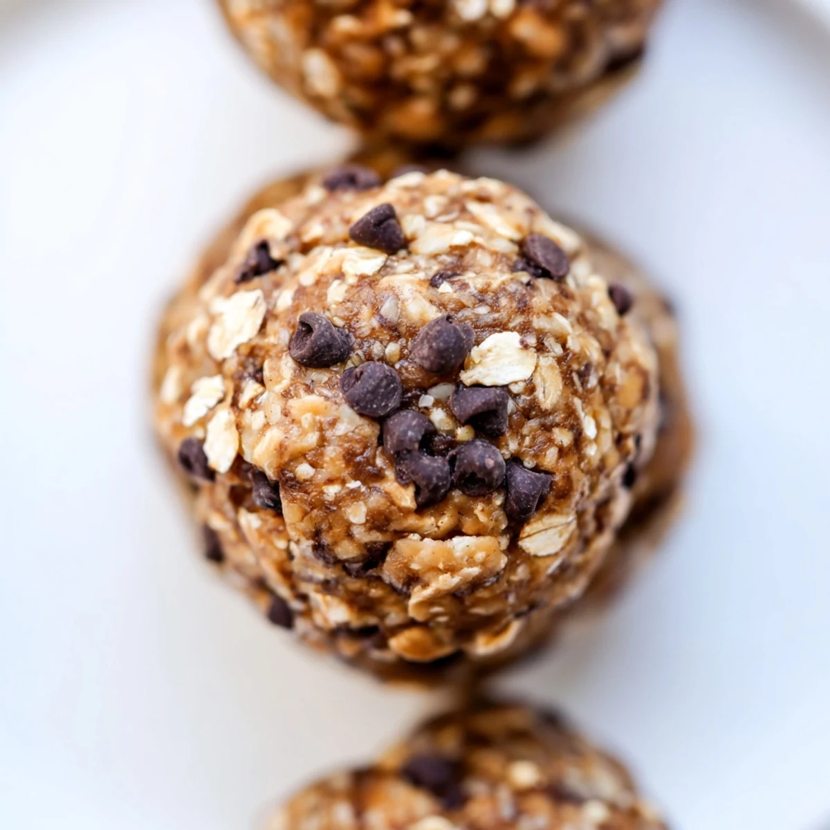 No bake chocolate peanut butter protein balls rolled in oats with melted chocolate chips