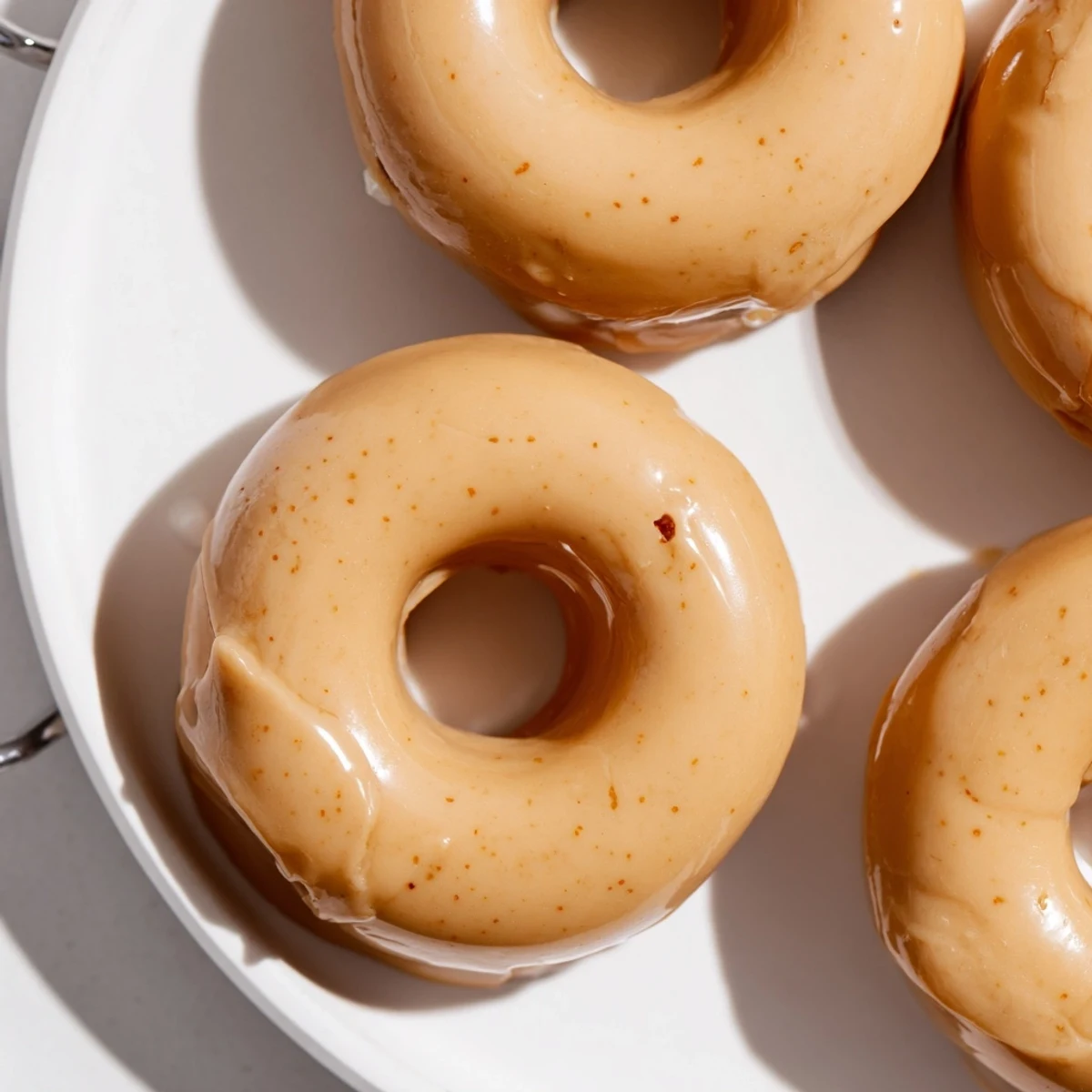 Plate of freshly glazed Earl Grey mochi donuts with their signature bouncy texture visible
