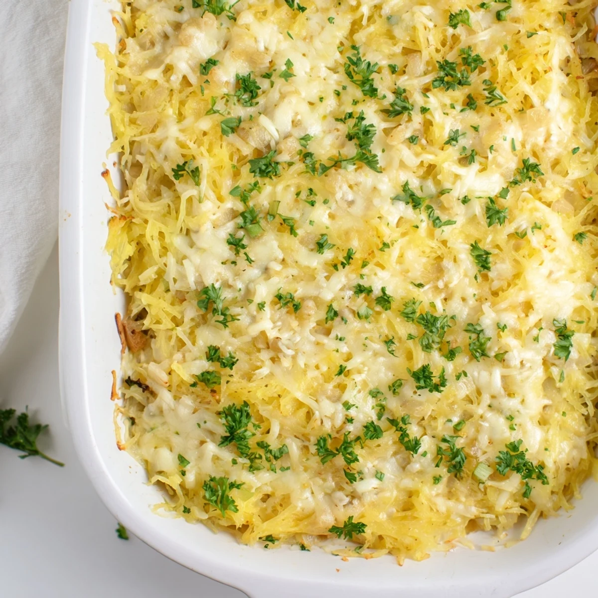 Creamy low-carb Spaghetti Squash Au Gratin casserole with cheesy strands baked in a dish