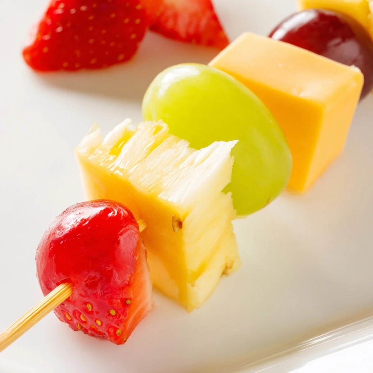 Fresh fruit and cheese kabobs featuring alternating cubes of Monterey Jack, cheddar, and sweet ripe seasonal fruits