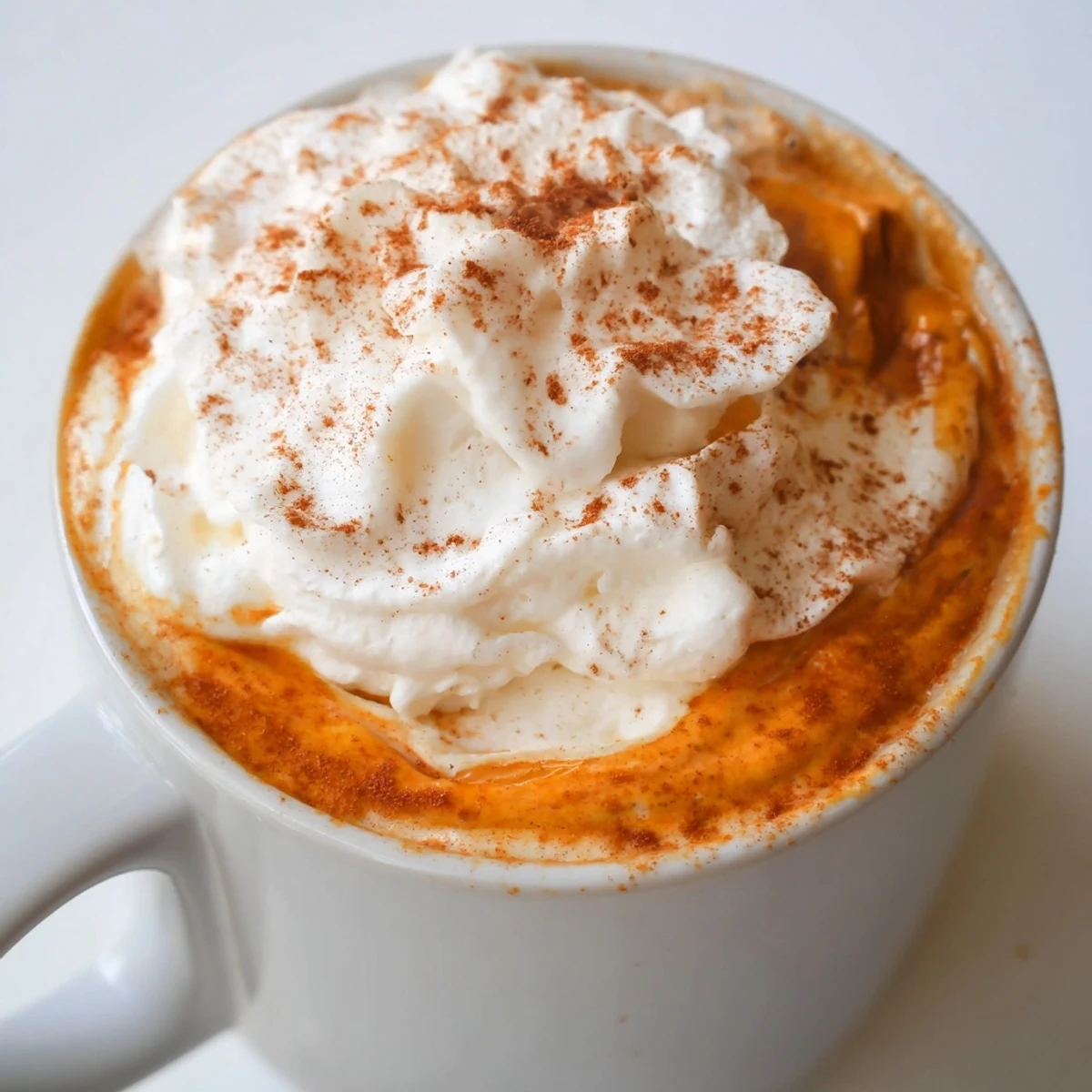 Creamy homemade pumpkin spice latte served in a cozy mug on an autumn morning