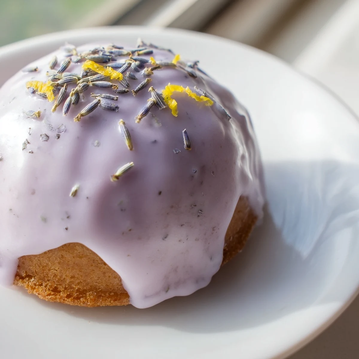 Tender mini lemon cakes with aromatic lavender glaze served alongside a teacup