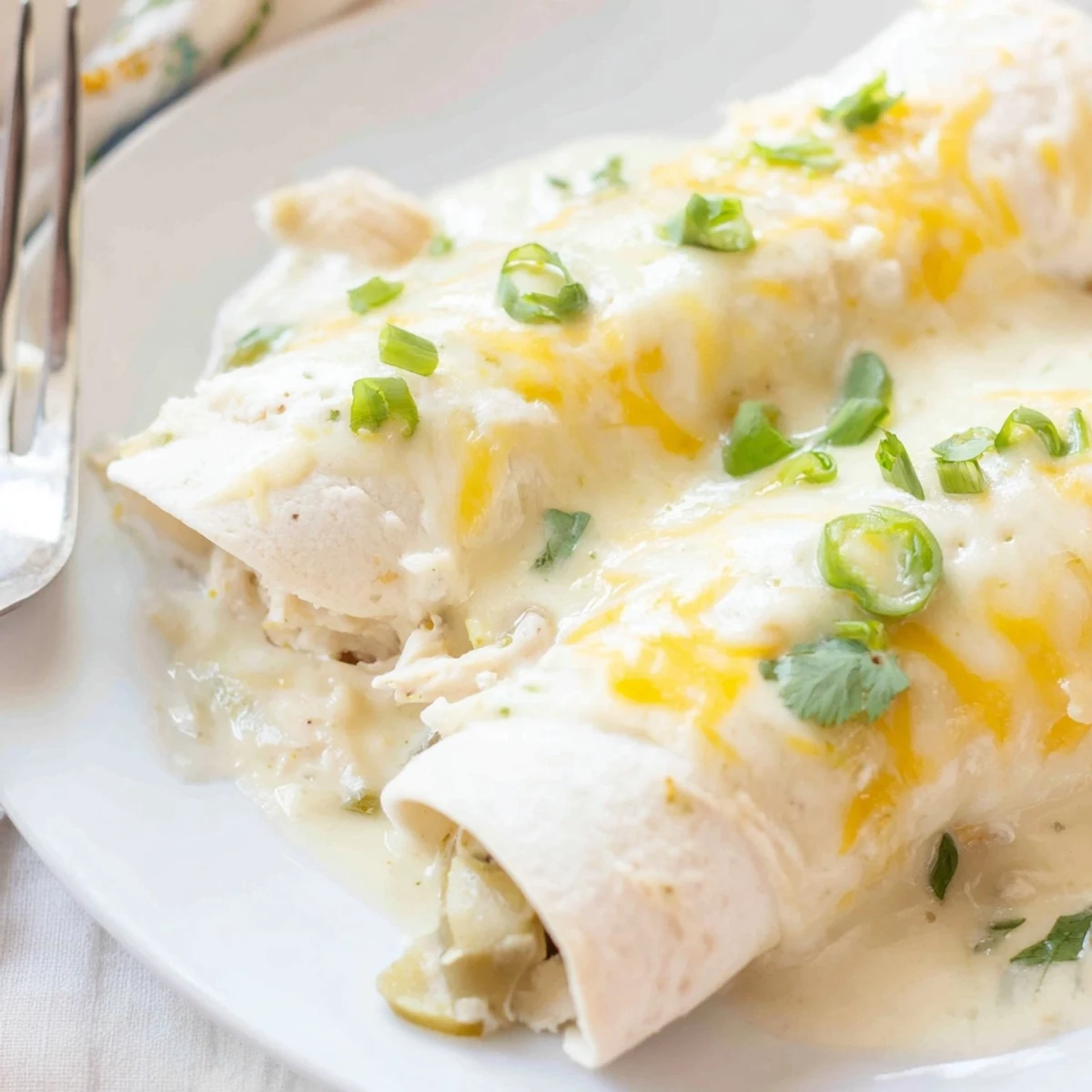 Family-style Creamy White Chicken Enchiladas served with Spanish rice and lime