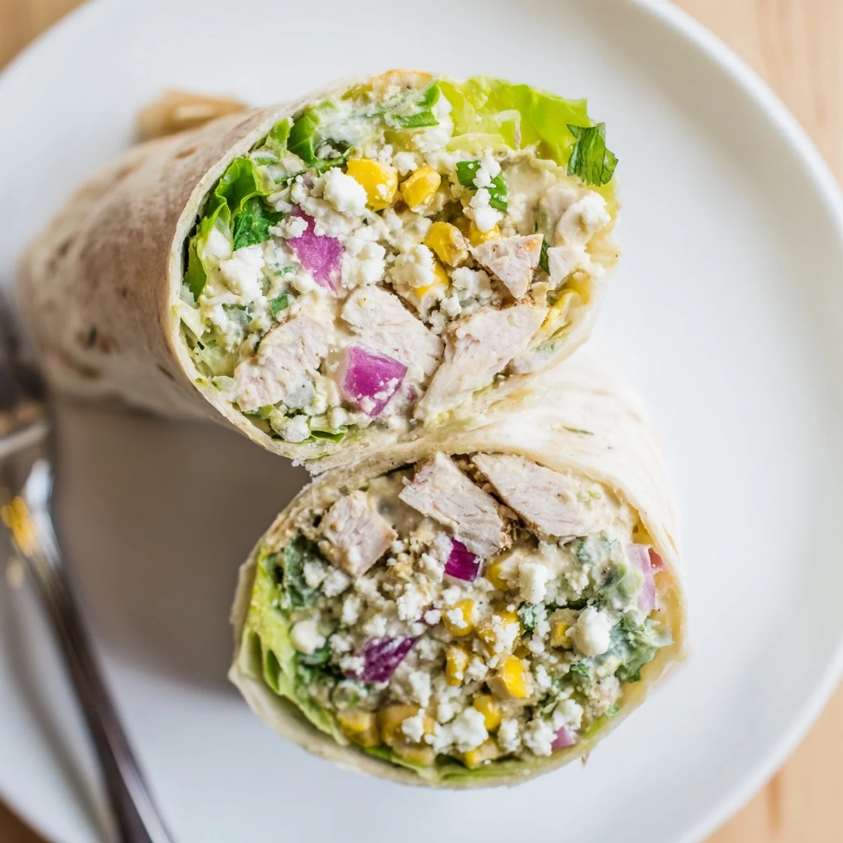 Quick Mexican Street Corn Chicken Wraps sliced, showing juicy grilled chicken and vibrant toppings  