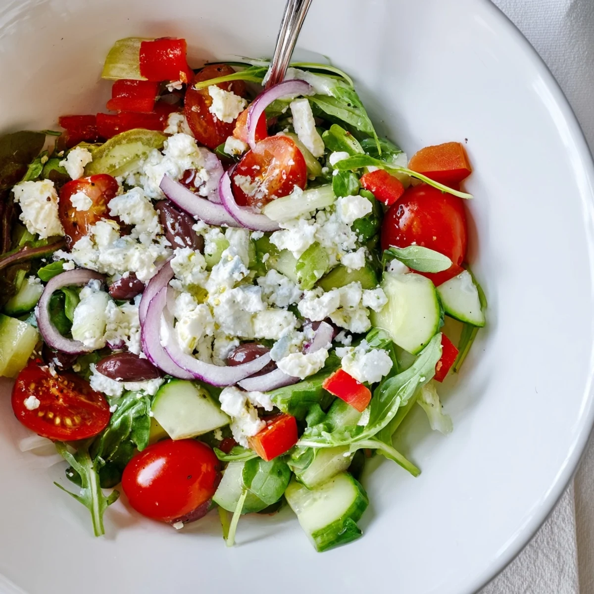 Easy Fresh Salad Recipe tossed in olive oil and lemon, ready to serve.