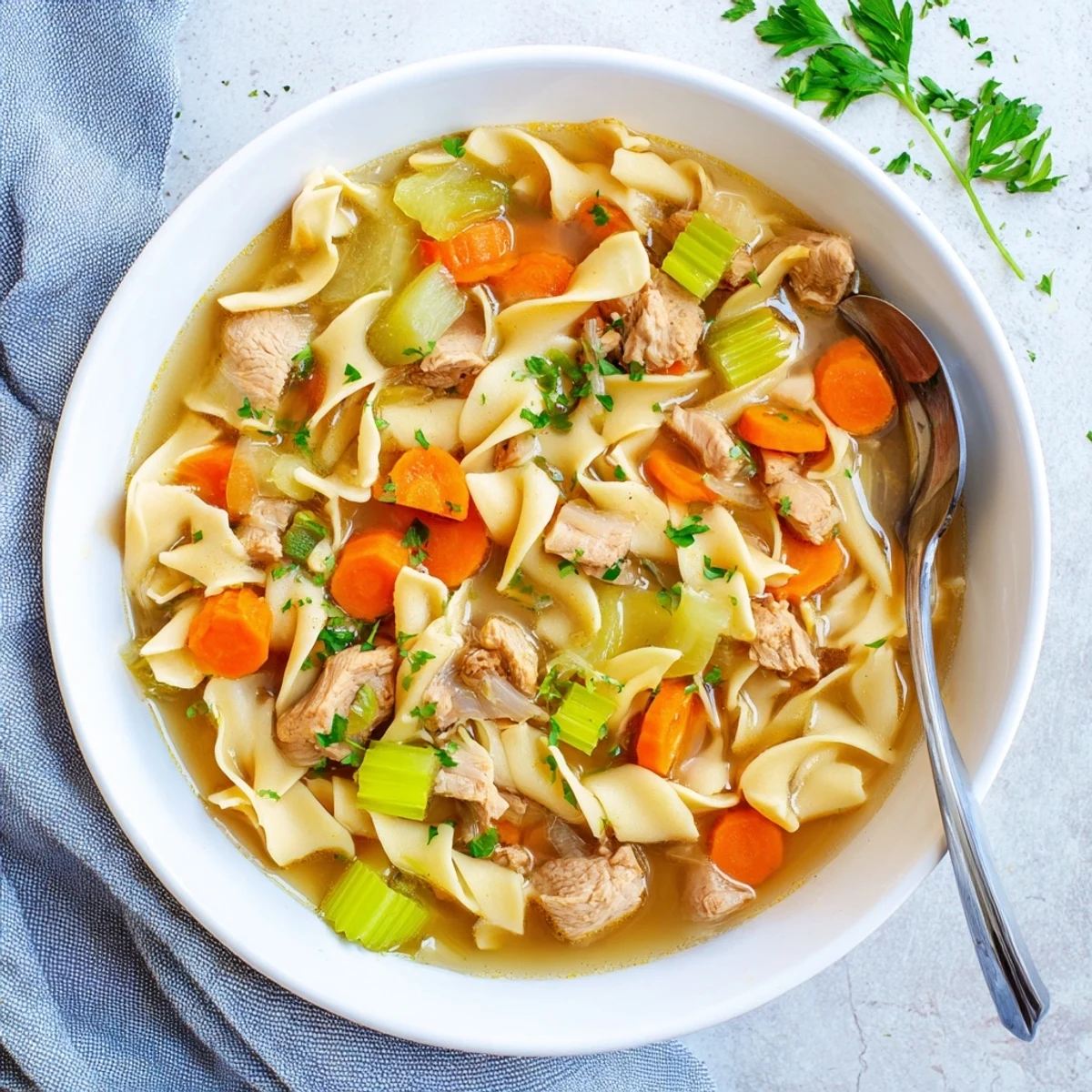 Creamy one pot chicken and noodles served in a rustic bowl topped with fresh parsley