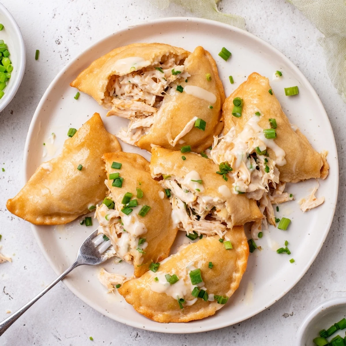 Flaky crescent rolls stuffed with seasoned chicken breast topped with homemade white parmesan sauce