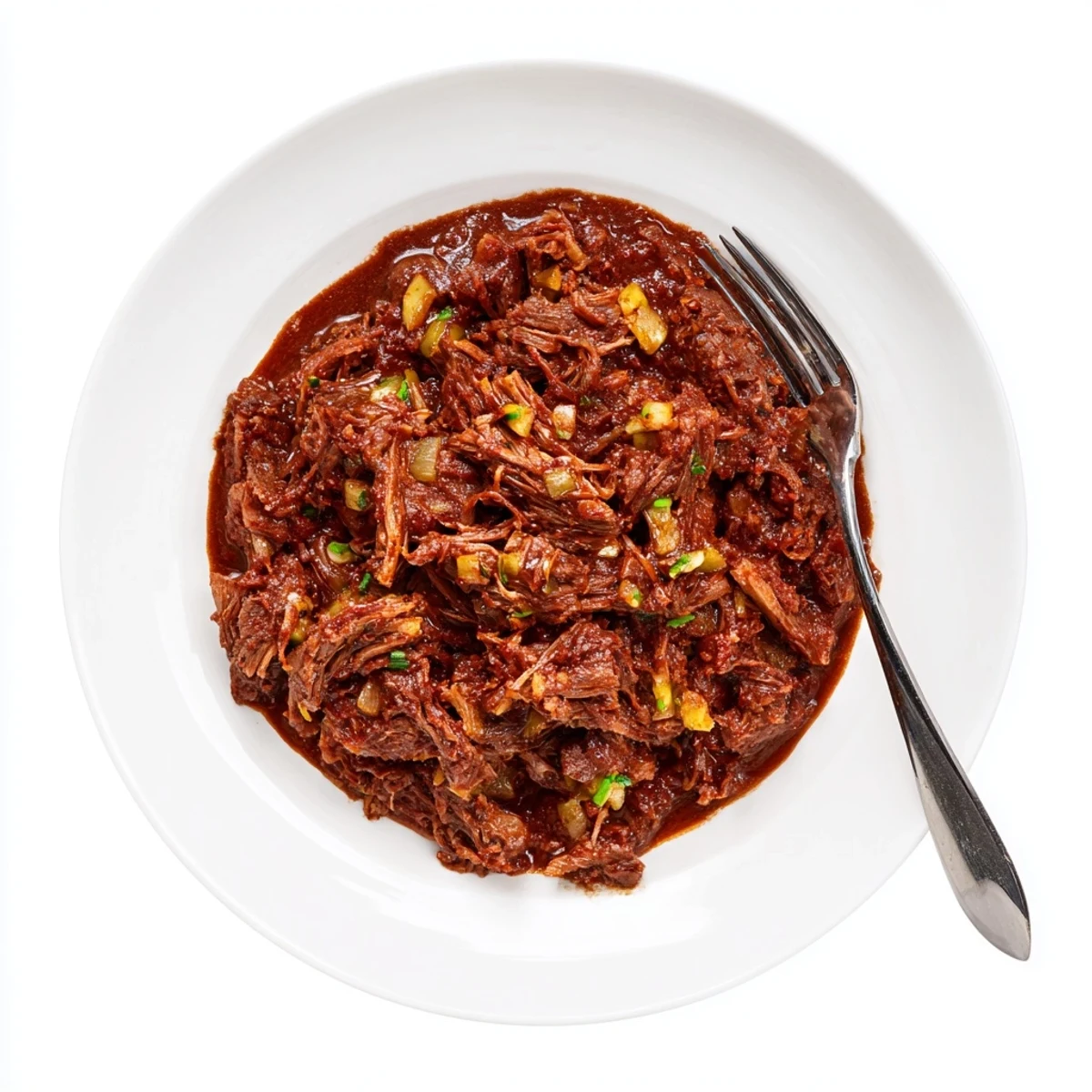 Tender slow cooker beef barbacoa shredded and piled high in a serving bowl