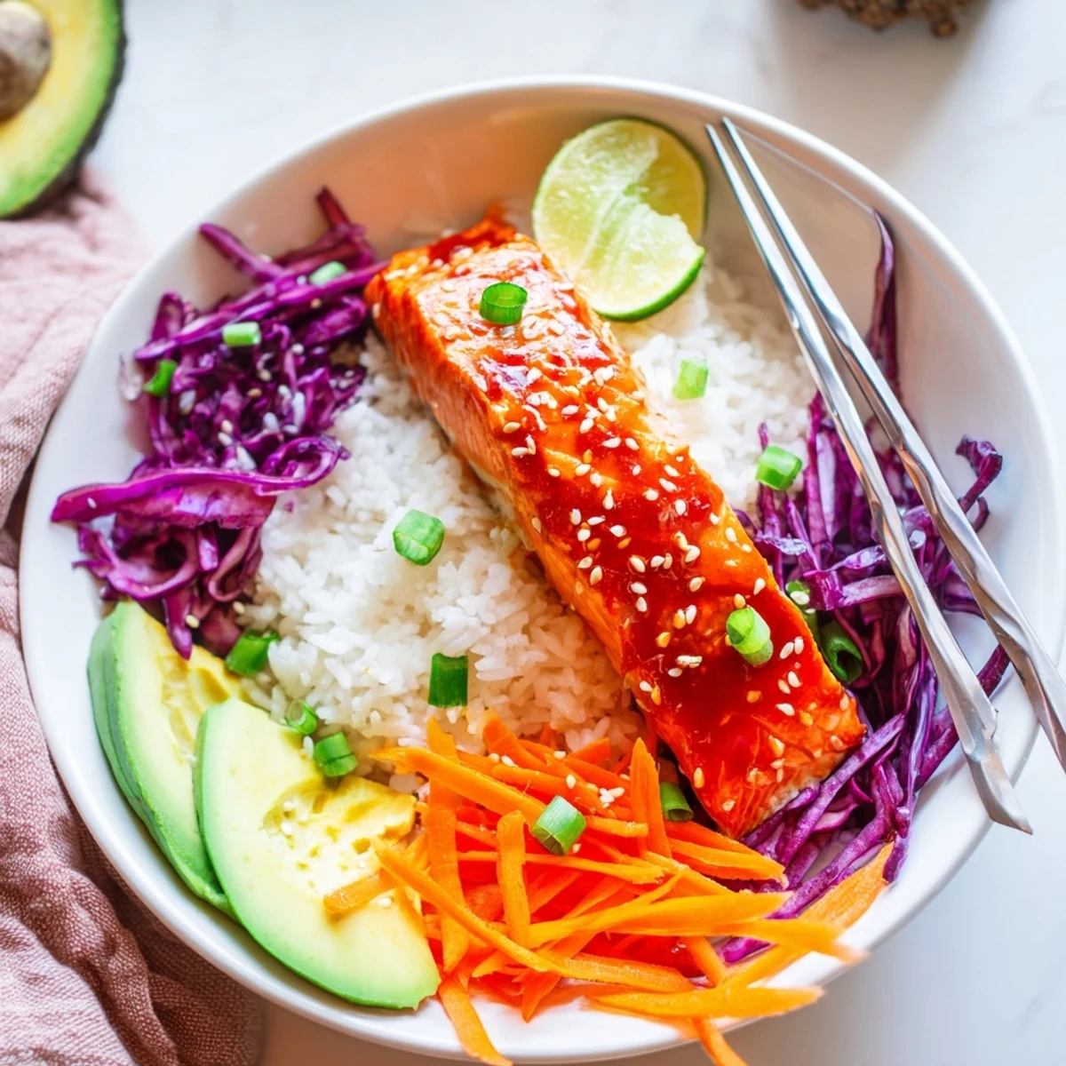 Tender glazed salmon nestled over crisp colorful vegetables in Sriracha Honey Glazed Salmon Bowls