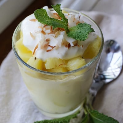 Mini pineapple condensed coconut milk dessert served in small glasses with juicy tropical fruit